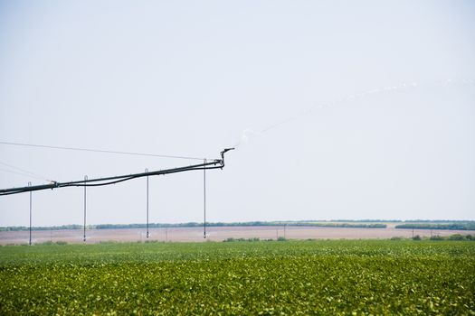 Automated farming irrigation sprinklers system on cultivated agricultural landscape field
