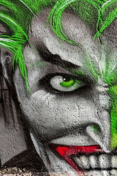 Detail of a graffiti with painting face. Street Art/Graffiti by unknown artist.