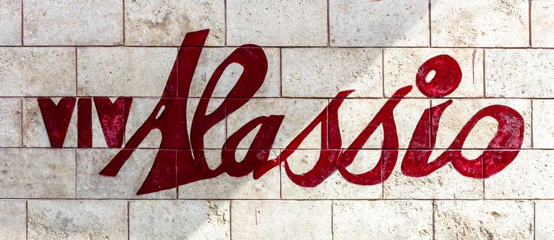 Name of the city of Alassio written on a wall. Precisely the VivAlassio event.