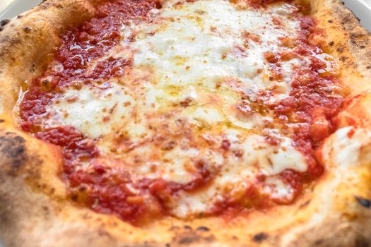 Pizza Margherita with mozzarella cheese and tomato sauce. Italian food, restaurant concept. Shallow depth of field.