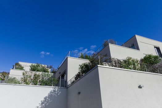 Complex of new apartment buildings with flower plants