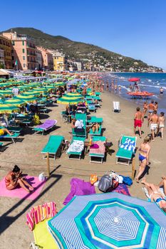 Alassio (SV), ITALY - August 21, 2017: Beach at Alassio (ITALY) with people sunbathing, swimming and relaxing on a warm summer day.