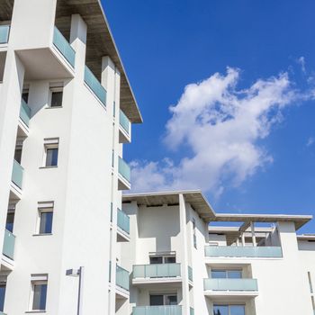 Modern apartment buildings on a sunny day with a blue sky. Facade of a modern apartment building.