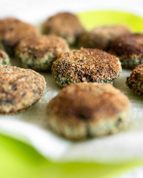 Vegetarian meatballs with spinach. Defocused blurry background.