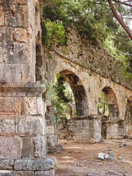 Ruins of aqueduct of ancient Phaselis city. Famous architectural landmark, Kemer district, Antalya province. Turkey.