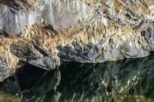 Han-sur-Lesse, Belgium - June 25, 2019: Grottes-de-Han 34 of 36. subterranean pictures of Stalagmites and stalactites in different shapes and colors throughout tunnels, caverns and large halls. reflection in Lesse River.