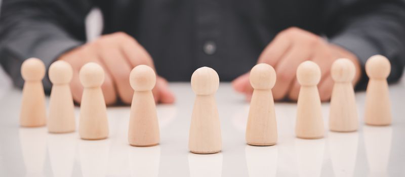 rows of wood cube people on business man background, promote leadership , business concept