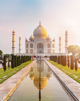 Sun rise at Taj Mahal front view reflected on the reflection pool, an ivory-white marble mausoleum on the south bank of the Yamuna river in Agra, Uttar Pradesh, India.