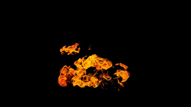 Fire flames on black background isolated. Burning gas or gasoline burns with fire and flames. Flaming burning sparks close-up, fire patterns. Infernal glow of fire in the dark with copy-space