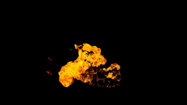 Fire flames on black background isolated. Burning gas or gasoline burns with fire and flames. Flaming burning sparks close-up, fire patterns. Infernal glow of fire in the dark with copy-space