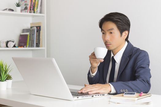 Asian Financial Advisor or Asian Consulting Businessman Drinking Coffee in Break Time. Asian Businessman in relax time
