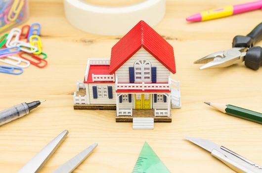 Home Improvement Concept. Home improvement background including Scissors Pen Paper Clip Sticky tape Pliers Pencil Cutter Water Level