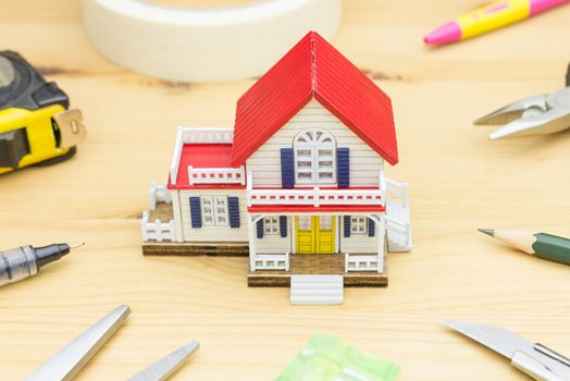 Home Improvement Concept. Home improvement background including Scissors Pen Measuring Tape Sticky tape Pliers Pencil Cutter Water Level
