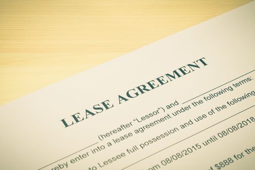 Lease Agreement Contract Document on Wood Table in Vintage Style. Legal document for business event