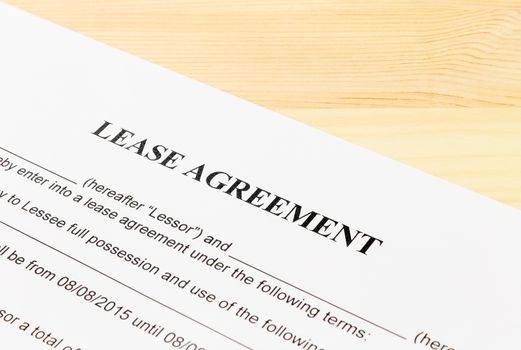 Lease Agreement Contract Document on Wood Table Left Angle View. Legal document for business event