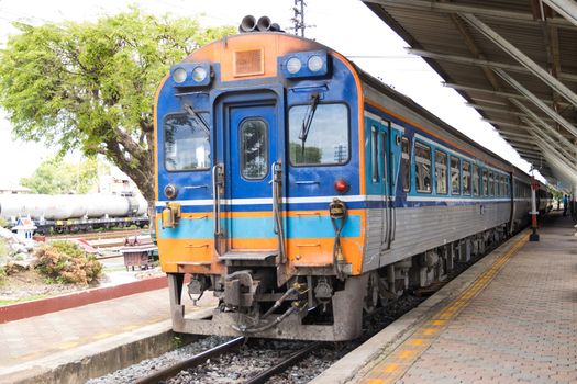 The train stops at train stations for passengers traveling  

in Thailand