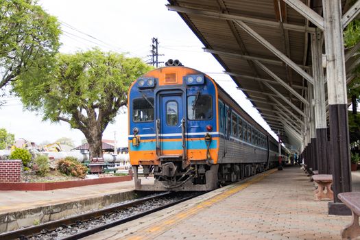 The train stops at train stations for passengers traveling  

in Thailand