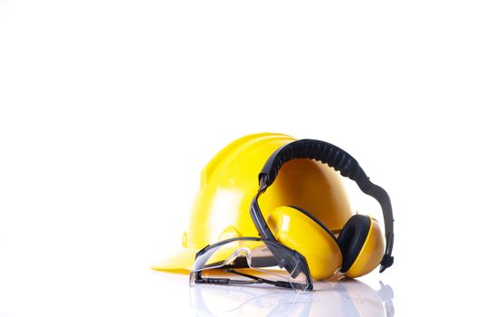 safety equipment for construction. Standard construction safety equipment. Personal protection equipment.Security tools for worker and Engineering. Yellow hard hat, Earphones, leather glove, safety glasses