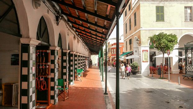 Menorca, Spain - june 28 - 2012 - View from the street of the city market of Ciutadella de Menorca, with arches and walls decorated with checkered majolica features