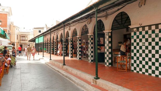 Menorca, Spain - june 28 - 2012 - View from the street of the city market of Ciutadella de Menorca, with arches and walls decorated with checkered majolica features