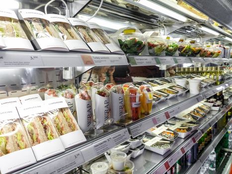 Bad habits of the human in modern times: shelf full of pre-packaged foods, ready to eat. Plastic abuse to contain ready-to-eat salads, sandwiches, fruit and vegetables.