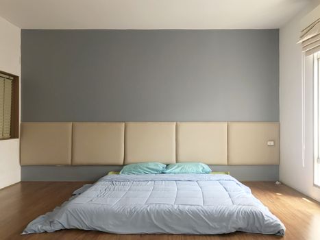 Home interior cozy bedroom in modern design with empty gray wall background.