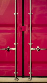 door face of metal cargo container. Pink Container door lock. Cargo pink container for transportation with closed door.  