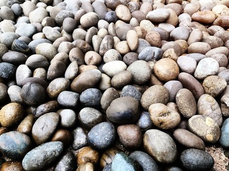 Nature background from sea pebbles. Pebble stones at the sea, Colorful Pebble Stones. Beach stones background.