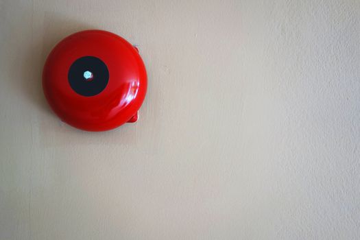 Red round call point for fire alarm. Red wall mounted Fire Alarm Bell in the Department store building.                               