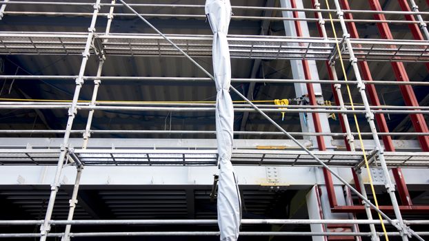 Scaffolding around the building for the construction. Construction building with Scaffolding around the building and High lifting cranes are working. 