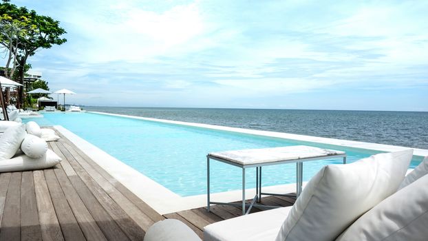 Swimming pool looking at blue sea view and blue sky background