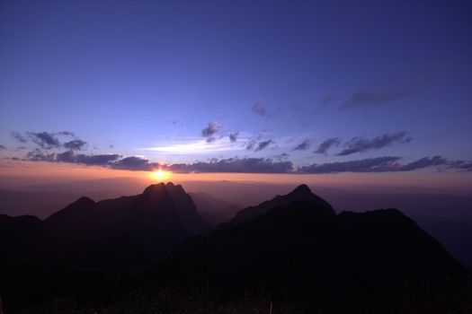 Twilight, beautiful orange light after sunset over the top of the hill.