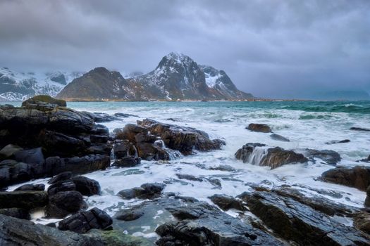 Rocky coast of fjord of Norwegian sea in winter. Skagsanden beach, Lofoten islands, Norway