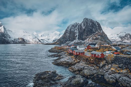 Famous tourist attraction Hamnoy fishing village on Lofoten Islands, Norway with red rorbu houses. With falling snow in winter