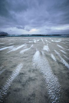 Rocky coast of fjord of Norwegian sea in winter. Skagsanden beach, Lofoten islands, Norway