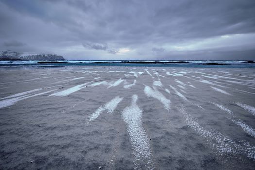 Rocky coast of fjord of Norwegian sea in winter. Skagsanden beach, Lofoten islands, Norway