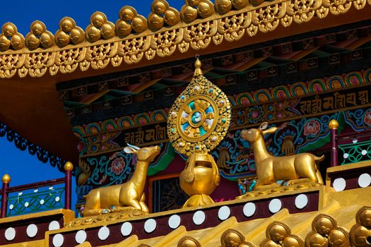 Buddhist Wheel of the Law (Wheel of the Dharma, Dharmachakra, Dharmacakra) on roof of Buddhist Monastery. Mcleod Ganj, Himachal Pradesh, India.