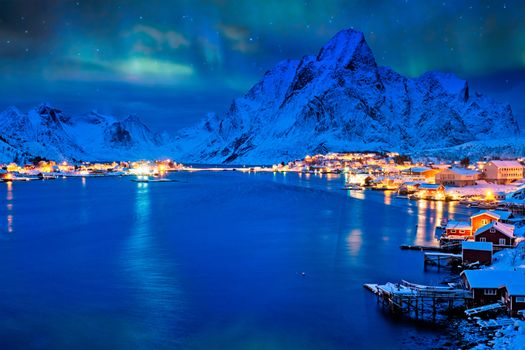 Reine village illuminated at night with Aurora Borealis. Lofoten islands, Norway