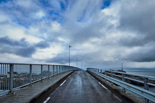 Road on bridge in Norway in winter with cloud sky