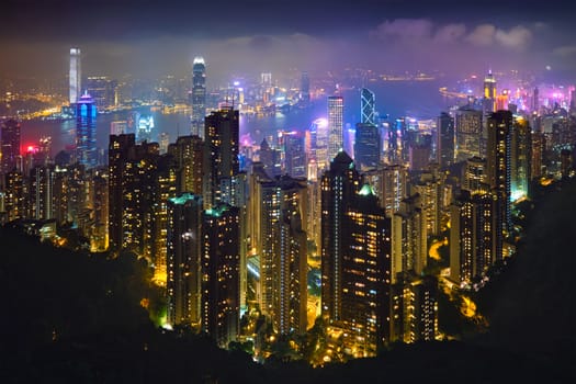 Famous view of Hong Kong - Hong Kong skyscrapers skyline cityscape view from Victoria Peak illuminated in the evening blue hour. Hong Kong, China