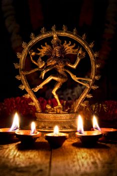 Maha Shivaratri or Diwali concept - Shiva Nataraja figurine with Diwali lights oil ghee candles, India