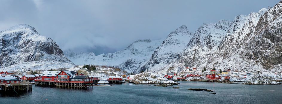 Panorama of traditional fishing village A on Lofoten Islands, Norway with red rorbu houses. With snow in winter