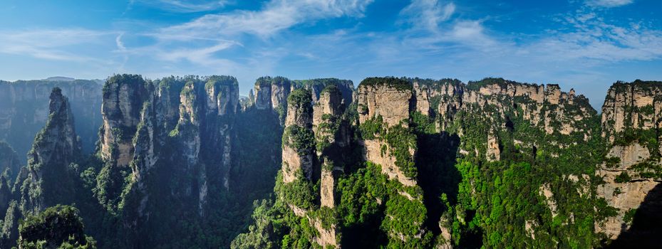 Panorama of famous tourist attraction of China Avatar mountains - Zhangjiajie stone pillars cliff mountains on sunset at Wulingyuan, Hunan, China