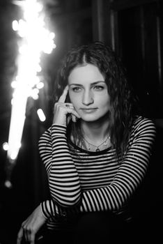 girl lit sparklers inside a wooden house late at night