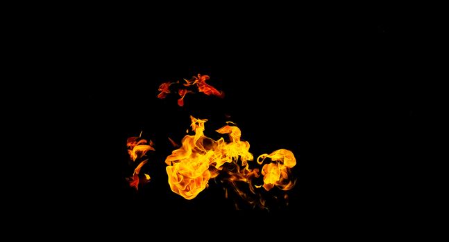 Fire flames on black background isolated. Burning gas or gasoline burns with fire and flames. Flaming burning sparks close-up, fire patterns. Infernal glow of fire in the dark with copy-space