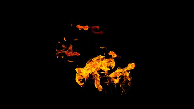 Fire flames on black background isolated. Burning gas or gasoline burns with fire and flames. Flaming burning sparks close-up, fire patterns. Infernal glow of fire in the dark with copy-space