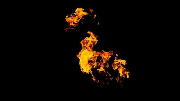 Fire flames on black background isolated. Burning gas or gasoline burns with fire and flames. Flaming burning sparks close-up, fire patterns. Infernal glow of fire in the dark with copy-space