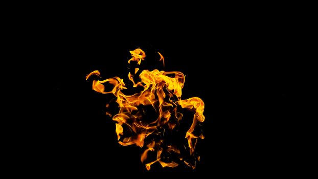 Fire flames on black background isolated. Burning gas or gasoline burns with fire and flames. Flaming burning sparks close-up, fire patterns. Infernal glow of fire in the dark with copy-space