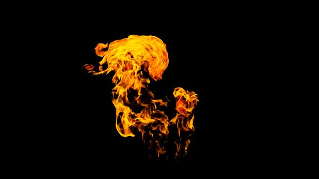 Fire flames on black background isolated. Burning gas or gasoline burns with fire and flames. Flaming burning sparks close-up, fire patterns. Infernal glow of fire in the dark with copy-space