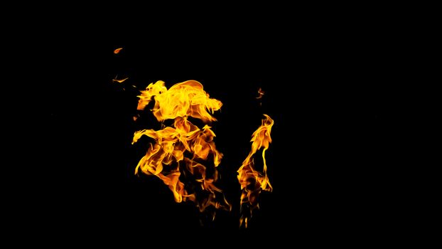 Fire flames on black background isolated. Burning gas or gasoline burns with fire and flames. Flaming burning sparks close-up, fire patterns. Infernal glow of fire in the dark with copy-space